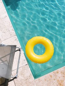 corner of a pool with float toy and chair