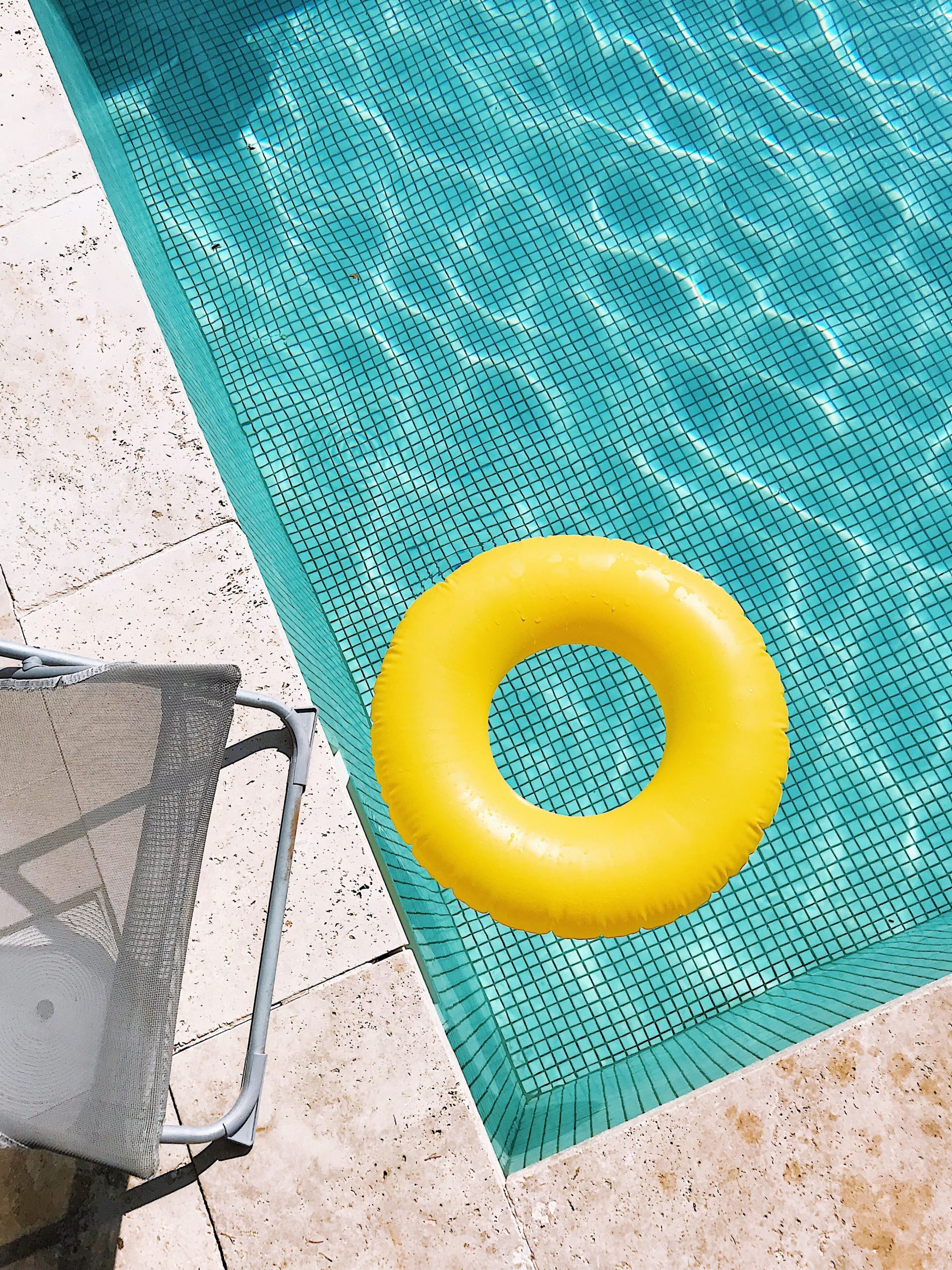 corner of a pool with float toy and chair